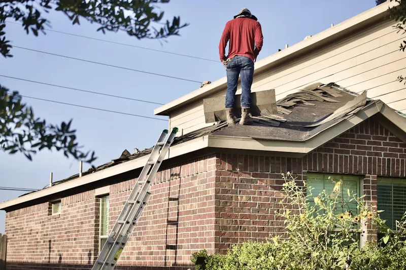 Professional roofer working on a residential roof in Stratton Meadows